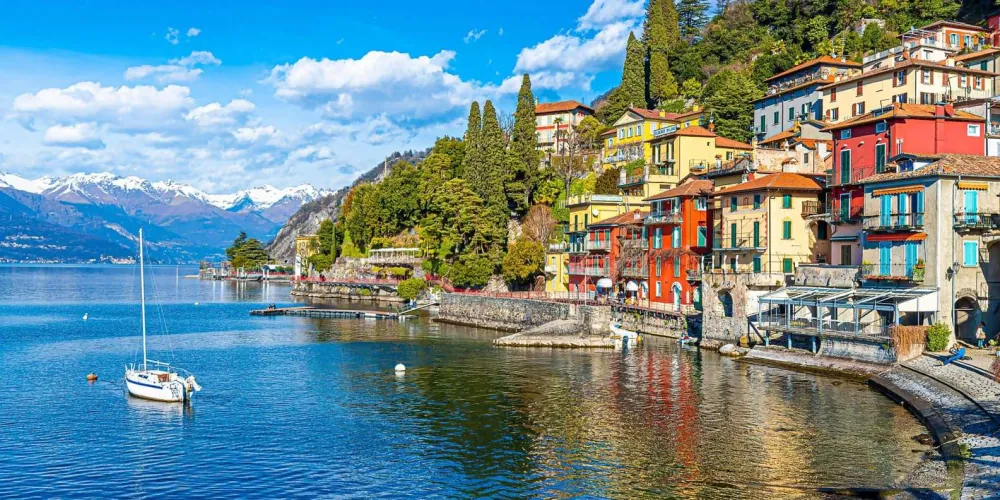 A ferry crossing Lake Como between mountain-backed villages