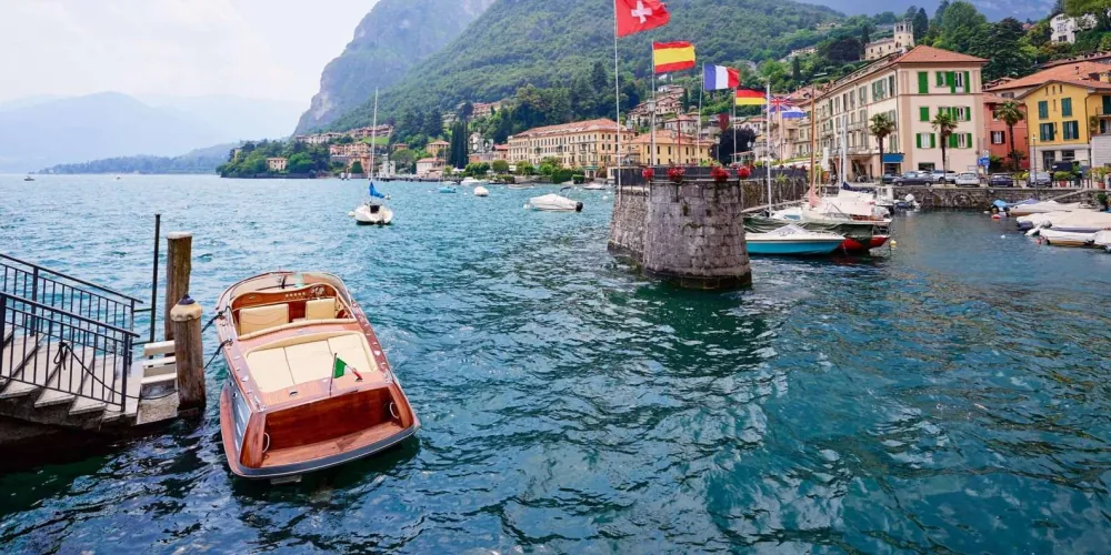 Lakeside promenade and moored boats at a Lake Como village