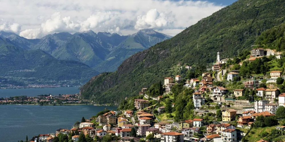 Panoramic Lake Como view of villas and forested slopes from the water